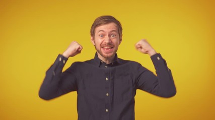 Young handsome man very happy and excited doing winner gesture with arms raised over isolated background