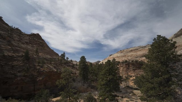 A timelapse of clouds flowing over Pine Creek in Zion National Park, located along the East Highway leading out of the park.