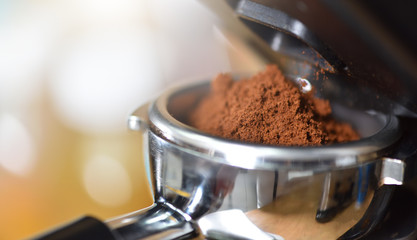 Freshly ground coffee in a port filter horn for a coffee machine. Close up, macro.