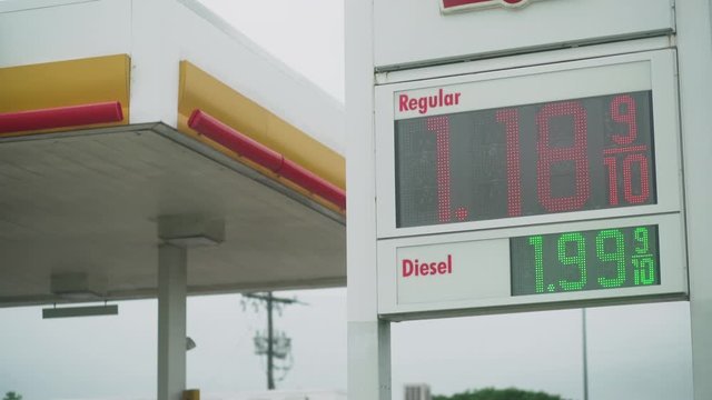 cheap gas prices on a digital marquee for regular and diesel