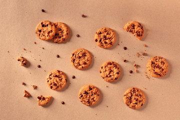 Chocolate chip cookies on a brown background, shot from the top