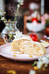 Healthy Home made sweet Apple strudel with raisins and cinnamon on wooden background with blooming fruit branches