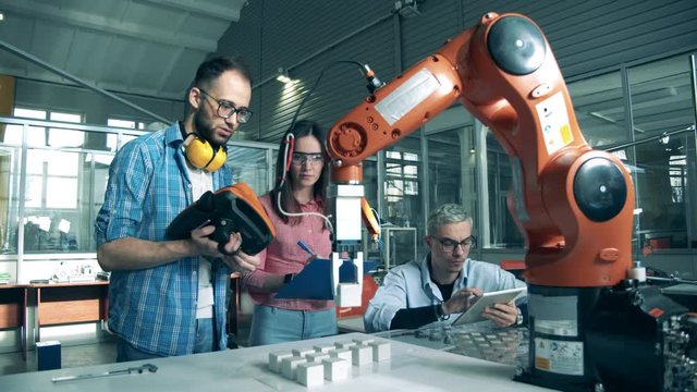 Team of engineers are conducting an experiment with robots