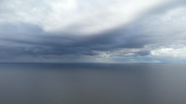 aerial footage of flying towards  storm clouds at sea