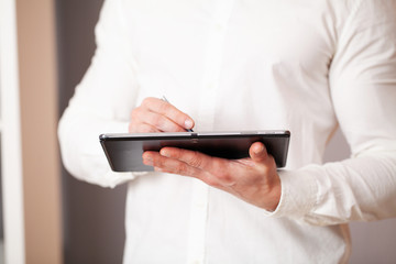 Man working on tablet at company office.