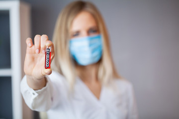 Doctor holds test tube with covid-19 test.