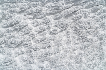 Icy texture of snow after a blizzard on a windy morning.