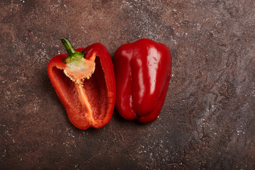 fresh red pepper cut in half on a wooden background