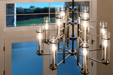 Grand large modern chandelier in the big new American house.