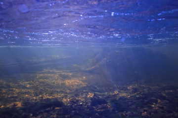 Fototapeta na wymiar sunbeams underwater photo / texture underwater landscape with sun rays, blue water sun in the ocean