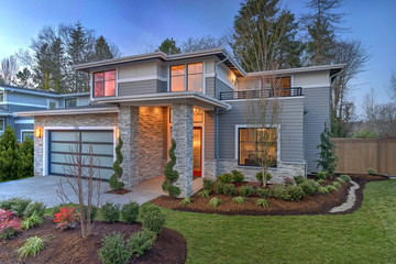Fototapeta na wymiar Modern contemporary house exterior with luxury details, landscaping, stone, wood, glass, lots of large windows.