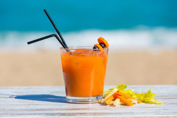 Carrot juice with the sea in the background