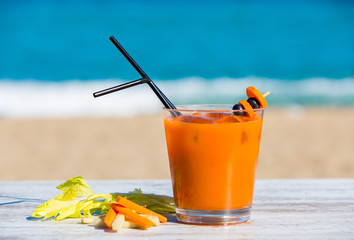 Carrot juice with the sea in the background