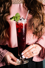 woman with fresh blueberries mocktail
