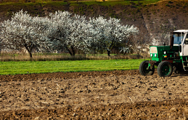 Farmer in tractor preparing land. Agricultural works at farmlands. agricultural work plowing land...