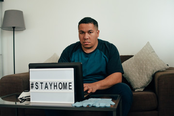 man thinks how to stop the spread of coronavirus. hashtag stay home.