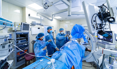 Neurosurgeon is operating with medical robotic surgery machine. Manual control by Minimally...