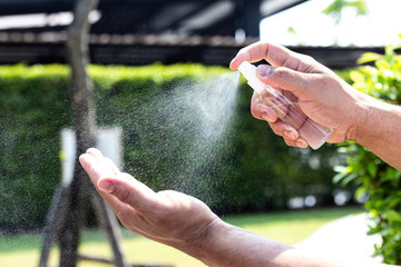 Man uses a spray of alcohol to get rid of bacteria and viruses, Inhibition and prevention of...
