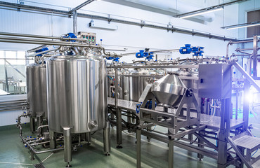 Interior of dairy factory with fermentation tank. Technology equipment at dairy farm. Sterile...
