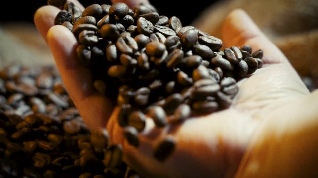 Hand that takes and drops Coffee beans in a bag of Yuta