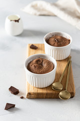 Warm Dessert Chocolate Fondant Lava Cake in ramekins. Side view. Cookbook, menu, recipe
