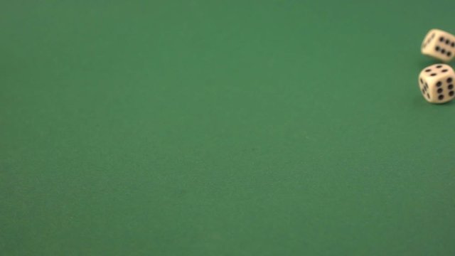 throwing dice on a green surface