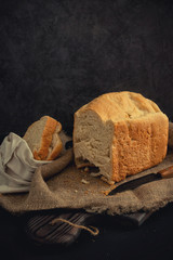 Fototapeta na wymiar Freshly baked bread lies on a burlap and on a cutting board.