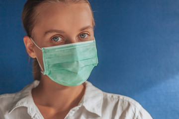 girl in a medical mask on a dark blue background