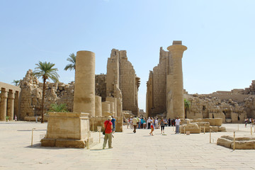 Tourists among the ancient ruins of Karnak Temple in Luxor, Egypt