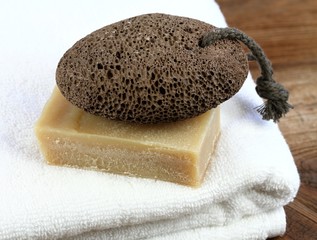 Bar of soap and and pumice stone in rustic style. Handmade olive oil  soap, pumice stone and white...