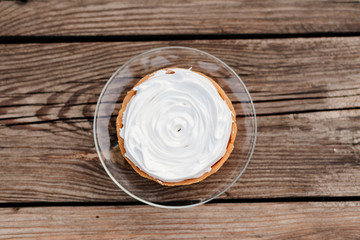 Meringue cakes. Cakes with protein cream on a wooden background.