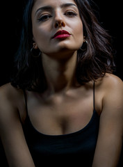 Naklejka premium Portrait of beautiful young woman on black background