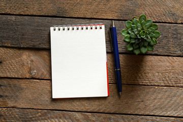 Blank notepad and on office wooden table