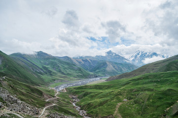 Green high mountain valley with blue sky and amazing clouds, Azerbaijan