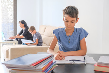 Online learning, distance education, online working from home. Family at home. Children doing homework with books, textbooks and with computer online, mother help to kids, working online