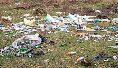 Waste landfill with rubbish heaps of bottles, bags and other garbage types