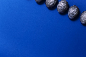 Eggs with marble stone blue effect painted with natural dye carcade flower on blue sparkling background
