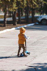 boy playing with push scooter