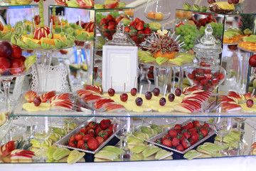 Dessert table for a party. Ombre cake, cupcakes, sweetness and flowers