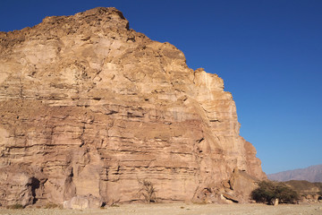 The high sandstone rock in the desert and the blue sky 