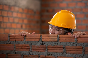 Industrial bricklayer installs bricks on construction sites in Asia.