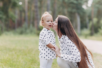 Beautiful Mother And her little daughter outdoors. Nature. Beauty Mum and her Child playing in Park...