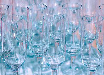 A lot of empty wine glasses. Close up at row of glasses prepare to service for dinner party