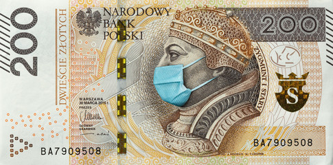 Coronavirus in Poland. Quarantine and global recession. 200 Polish zloty banknote with face mask against infection. Global economy hit by covid19.National Bank of Poland prints money to save their ass
