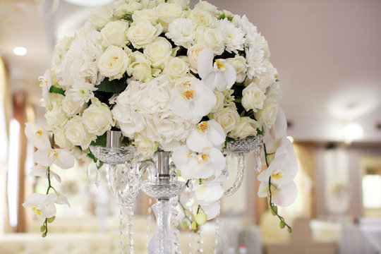 luxury wedding decorations with bench, candle and flowers composition on ceremony place