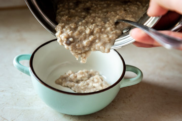 Healthy breakfast oatmeal porridge in bowl. Warm porridge oats, vegan vegetarian weight loss dieting breakfast food