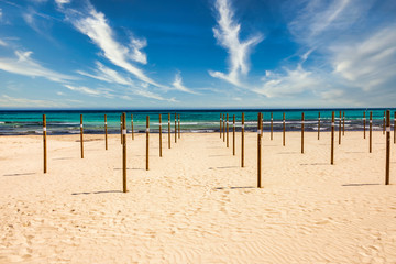 On Sa Coma on the Mediterranean island of Mallorca there are wooden poles in the beach on which the parasols are placed at the start of the season