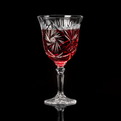 Crystal glass of wine on a black background in the studio