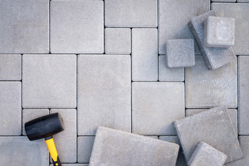 Paving stones paving background. Installing tools on foreground