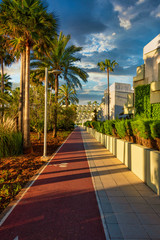 A cycle and footpath on the beach of Sa Coma on the Mediterranean island of Mallorca behind a holiday resort at sunrise